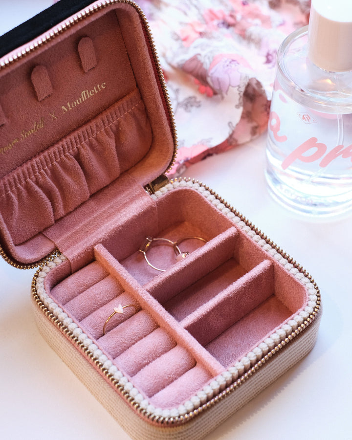 boite à bijou ouverte avec intérieur rose et bagues à l'intérieur
